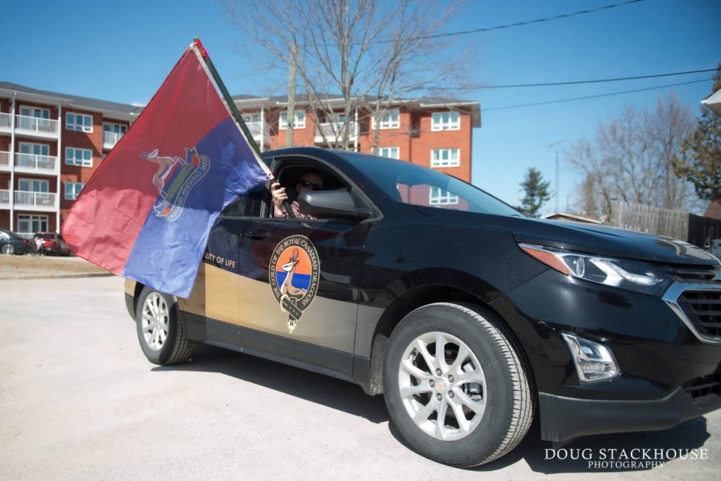 Dragoons' vehicle with the regimental flag held out the window