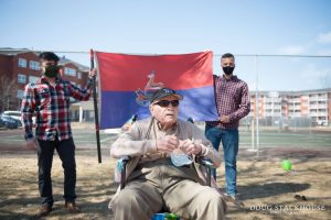 LCol John Beswick with the regimental flag displayed behind him